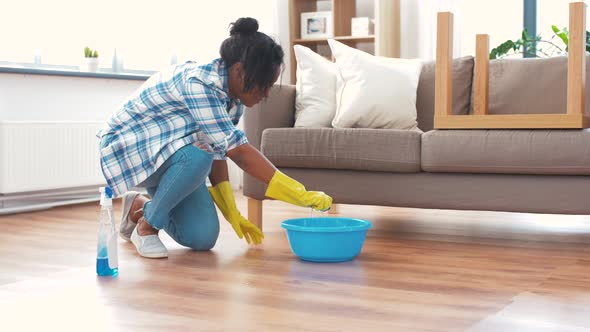 African Woman with Sponge Cleaning Floor at Home 38