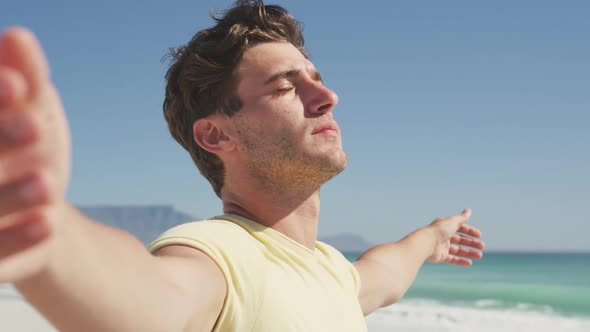 Caucasian man enjoying the fresh air at beach