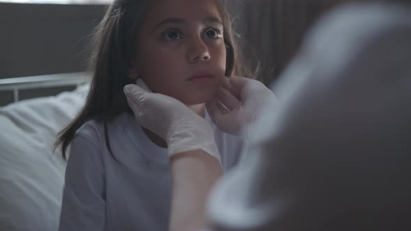 The Doctor Examines a Little Girl Patient, Looks at the Throat.