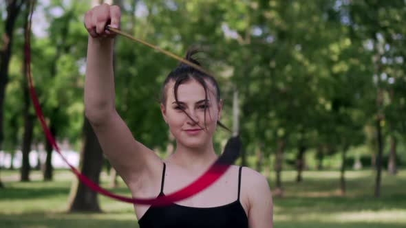 Young Woman Gymnast is Exercising