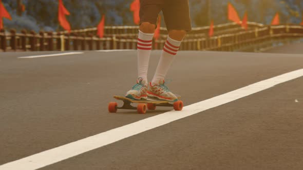 Portrait Boy with a Longboard on a Beautiful Road