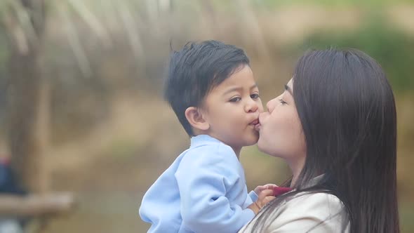 Little Boy Kissing His Mother