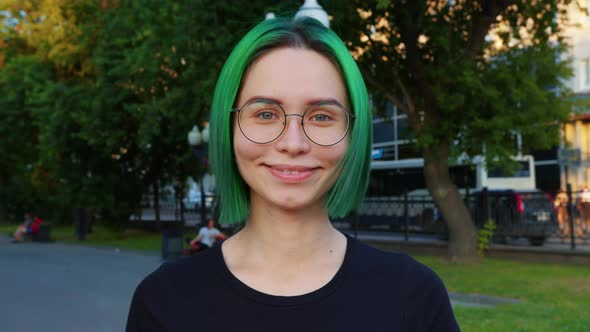 Girl Looking at Camera Smiling Blinking