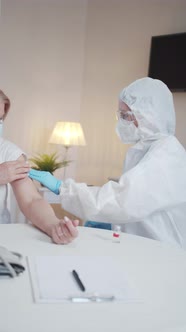 An Elderly Woman Thanks the Doctor for the Vaccination