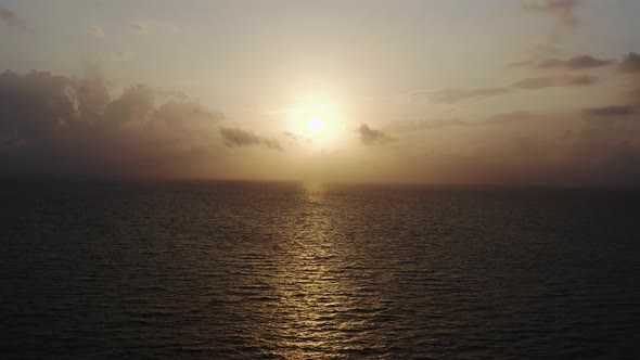 Colorful Bright Clouds During Sunset Over the Sea or Ocean Aerial Drone View