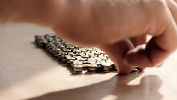 Hand taking a roller chain