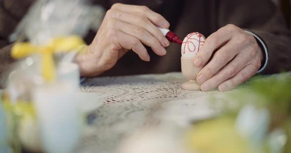 Senior Man Coloring Easter Eggs