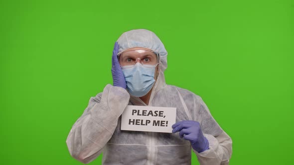 Doctor in PPE Suit with Text Inscription Slogan  Please Help Me n Chroma Key Covid19 Epidemic