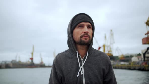 Round Footage Caucasian Handsome Man Wearing Hat and Grey Hoodie Posing Looking on Camera with