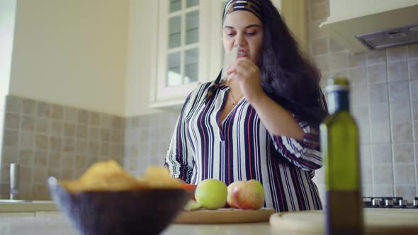 Plump Girl Is Cooking in the Kitchen