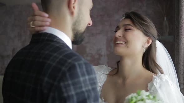 Close-up Shot of Beautiful Bride with Diadem on Her Head, with Bouquet of Flowers and in a Chic