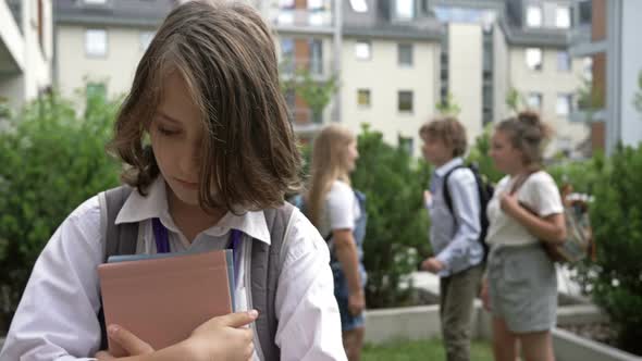 Group of Schoolchildren Mocks a Classmate. Childhood Cruelty. School Bullying