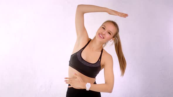 Smiling Attractive Yoga Woman Showing Stretching Exercise Isolated at White Studio Background