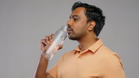 Happy Indian Man Drinking Water From Glass Bottle