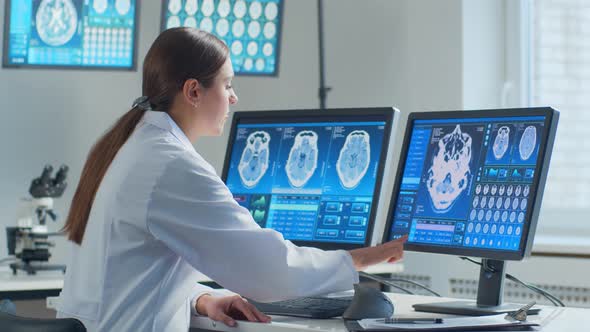 Professional medical doctor working in hospital office using computer technology.