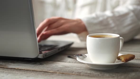 Protable Coffee Hand Computer. A Working Girl At A Laptop Computer