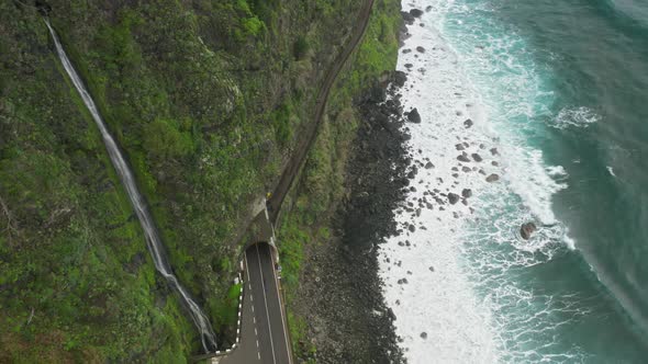 Aerial Footage of Scenic Route with a Tunnel Inside a Volcanic Rock