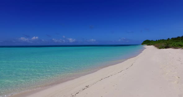 Wide angle flying abstract shot of a summer white paradise sand beach and blue ocean background in c