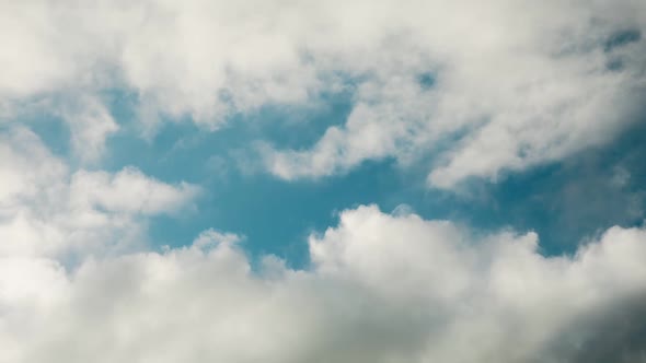 Flying clouds, blue sky timelapse background