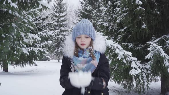 Portrait of a Happy Blueeyed Teenage Girl in a Snowy Park