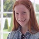 Red Haired Girl with Freckles Smiling Against White Window - VideoHive Item for Sale