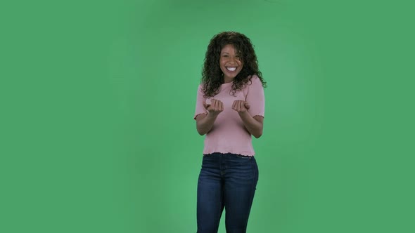 Portrait of Beautiful African American Young Woman Is Looking at Camera with Enthusiastically Waving