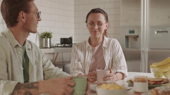 Spouses Talking over Breakfast