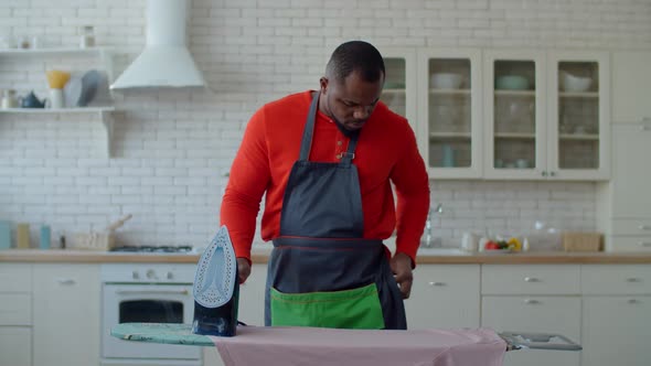 Black Male Distracting By Phone Call During Ironing