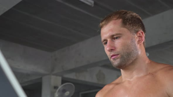 Topless athletic man workout running on treadmill at fitness