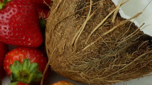 Rotation of juicy strawberries and coconut. Top view, 360 degree rotation, extreme close-up.