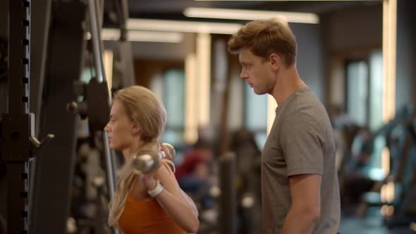 Sexy Fit Girl Making Barbell Squats in Sport Club. Fitness Couple Workout at Gym alt