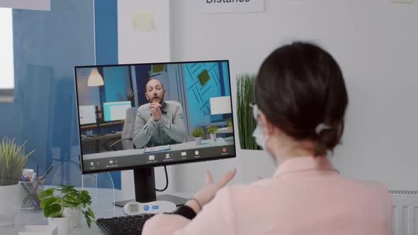 Freelancer with Protection Face Mask Talking with Executive Manager on Computer