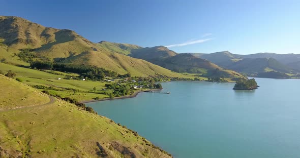 Cinematic aerial view over Port Levy, a Maori settlement on Banks Penninsula in Canterbury New Zeala