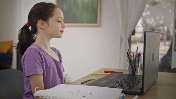 Little girl attending an online lesson during the COVID-19 lockdown