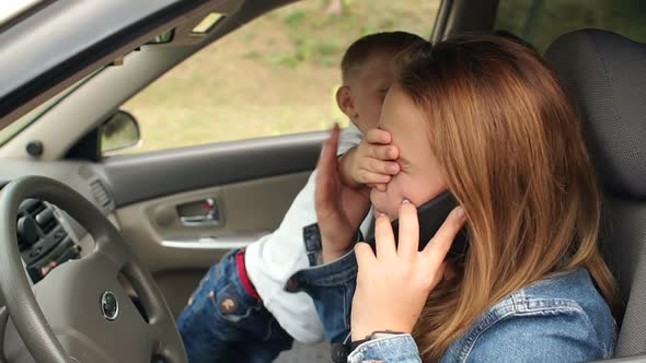 A Naughty Child Indulges in a Car He Prevents His Mother From Talking on Phone