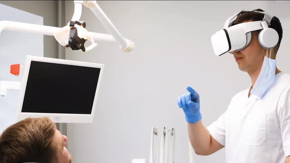 A Dentist in 3D Glasses Works with a Client in the Clinic of the Future