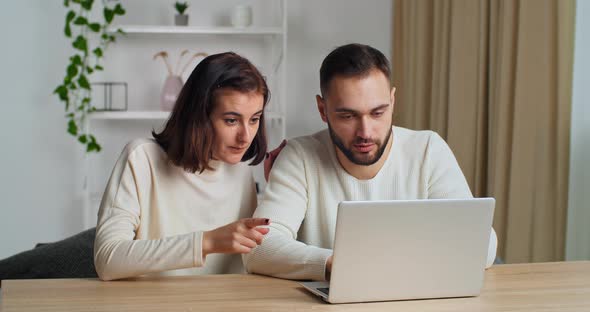 Happy Caucasian Millennial Family Couple Using Laptop for Ecommerce Doing Online Shopping Buying