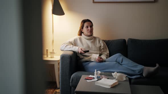 Ill Woman at Home Sitting on Sofa Sneezing Watching Tv Female Having Runny Nose