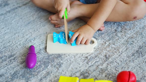 Cute Little Toddler Girl Playing at Home with Eco Wooden Toys