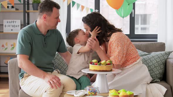 Happy Family with Birthday Cake at Home Party