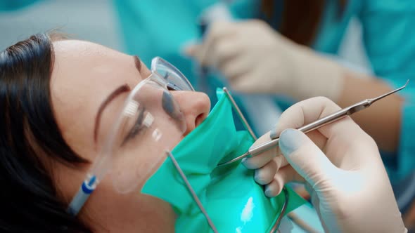 Female patient's face during tooth treatment