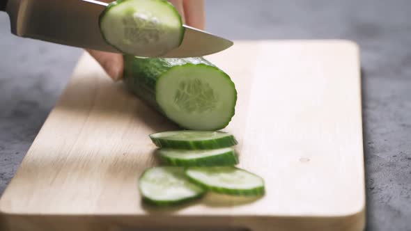 Woman Slicing Cucumber