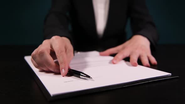 woman in a business suit proposes to sign agreement, promoting printed contract