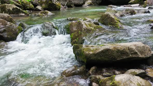 Mountain River Waterfall Flowing Between Rocky Shores in Carpathians Mountains Ukraine