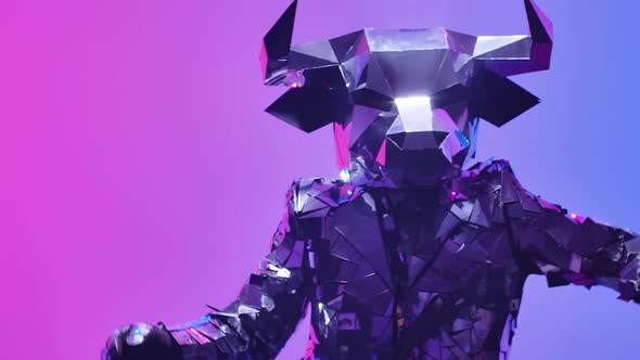 Shiny Bull in Costume Made of Mirrors Dancing Robot Dance on Neon Blue Pink Studio Background