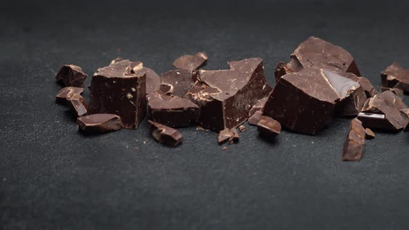 Dark or Milk Organic Chocolate Pieces on Dark Concrete Background