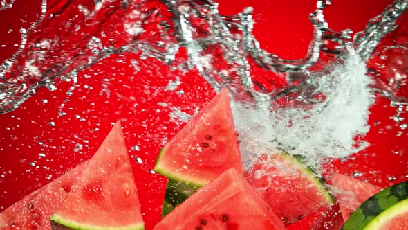 Super Slow Motion Shot of Flying Fresh Watermelon Slices and Water Side Splash at 1000Fps.