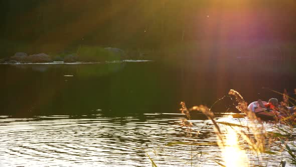 Dad and daughter in rubber boat enjoying tranquil Nordic summer