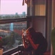 Woman photographer taking a picture of a plant on the balcony - VideoHive Item for Sale