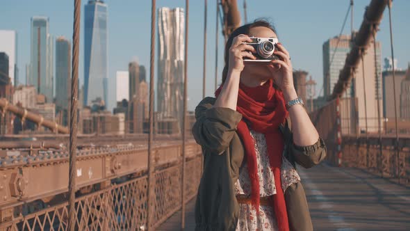 Attractive tourist with a retro camera 